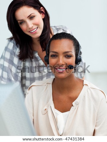 Radiant manager checking his employee's work at a computer