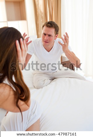 Angry couple having an argument  in the bedroom