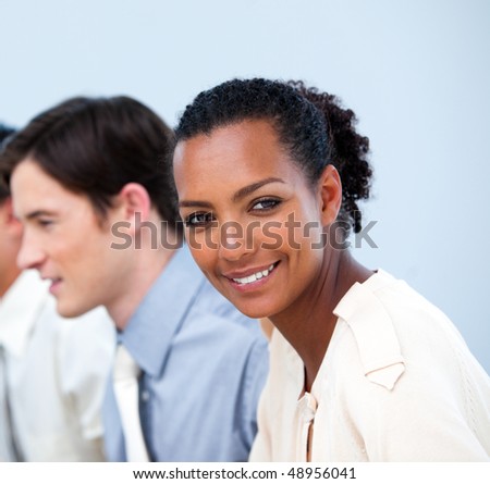 Close-up of smiling young business people at work