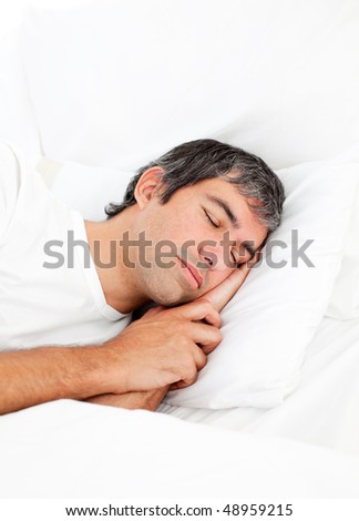 Portrait of an attractive man sleeping in his bed