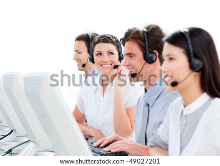 Portrait of enthusiastic customer service agents working in a call center against a white background