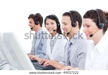 Multi-cultural customer service agents working in a call center against a white background