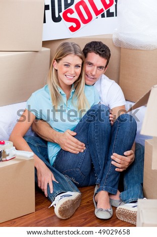 Caucasian couple embracing after move in at home