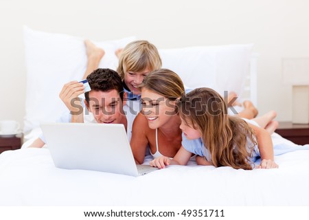 Animated family buying online lying down on bed at home
