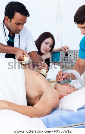 A diverse medical team resuscitating a patient at the hospital