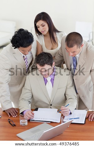 Serious International business people studying a document in a meeting
