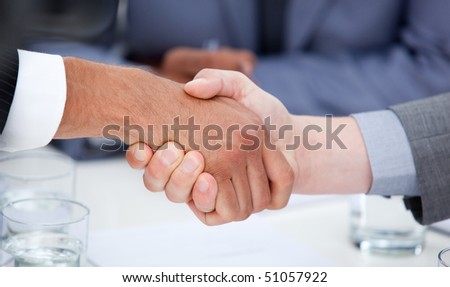 Close-up of confident business people closing a deal in a company