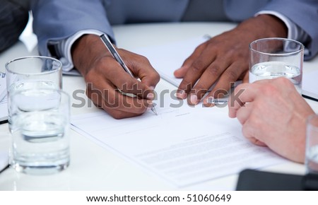 Close-up of ambitious business people closing a deal in a company