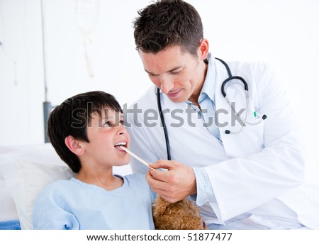 Cute little boy attending a medical exam sitting on a hospital bed