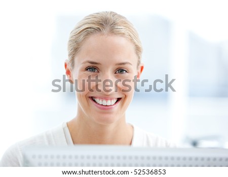 Portrait of a smiling businesswoman working at a computer in the office