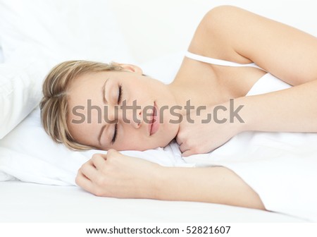Attractive woman sleeping on a bed at home