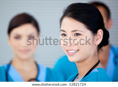 Smiling female doctor with her teamates in the hospital