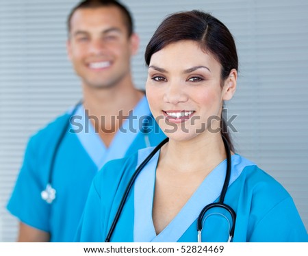 Bright female doctor looking at the camera in the hospital