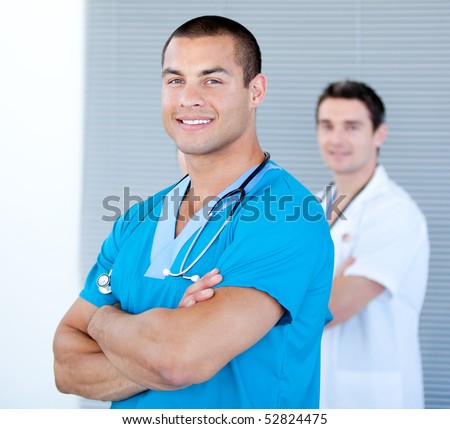 Handsome male doctor looking at the camera in the hospital