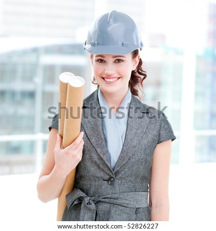 Portrait of a self-assured female architect holding blueprints in the office