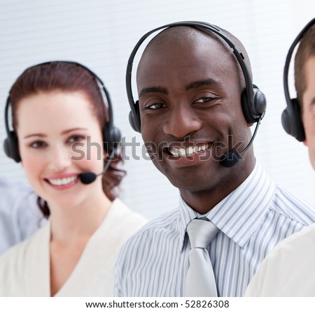 Happy customer service representatives with headset on standing in a line