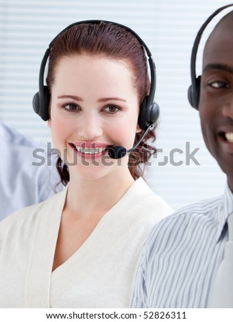 Smiling customer service representatives with headset on standing in a line