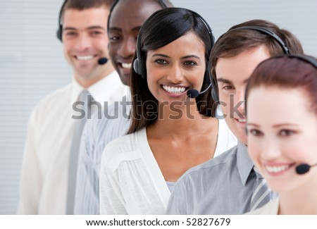 Multi-ethnic customer service representatives with headset on standing in a line