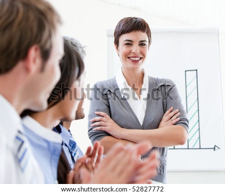 Cheerful business people applauding a good presentation in the office