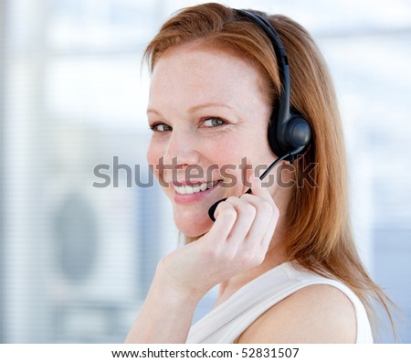 Smiling sales representative woman with an headset against white background