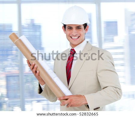 Smiling architect holding a blueprint  in the company