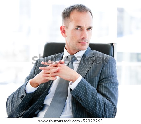 Self-assured businessman looking at the camera in the office