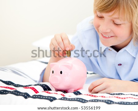 Happy children using a piggy bank at home