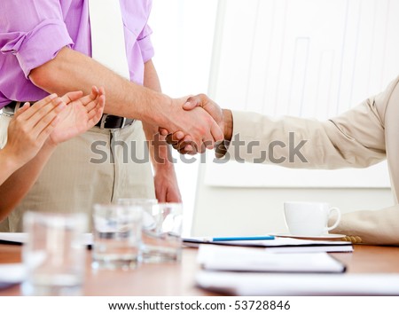 Close-up of two business partners closing a deal. Business concept.