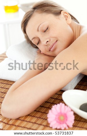 Portrait of a relaxed woman having a massage with stones at the spa
