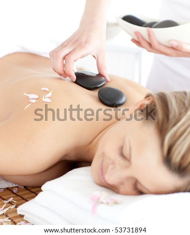 Delighted woman having a flower on a massage table