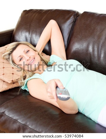 Relaxed woman using a remote in the living-room