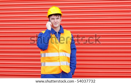 Handsome male engineer talking on the phone at work