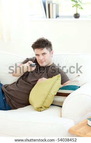 Self-assured man is relaxing in the living-room