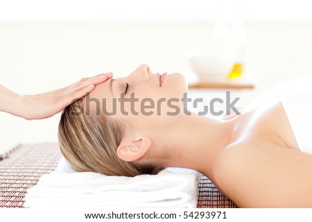Close-up of a relaxed woman receiving a head massage in a Spa center