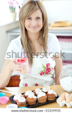 Caucasian woman cooking cakes in the kitchen at home