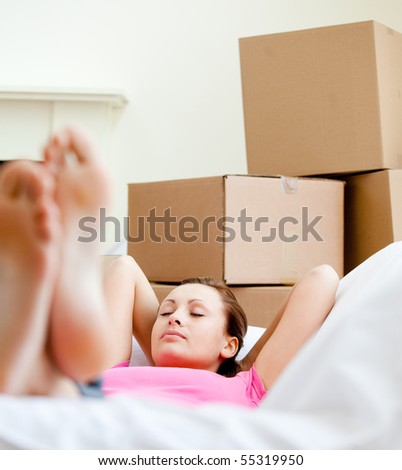 Attractive woman having a break between boxes at home