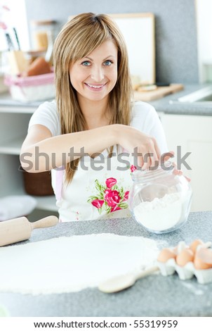 Portrait of a cute woman preparing a cake in the kitchen at home
