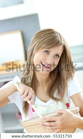 Teen woman preparing a cake in the kitchen at home