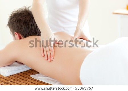 Caucsasian young  man receiving a back massage in a Spa Center