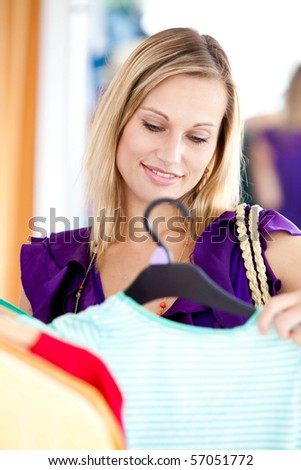 Bright woman is doing shopping in a clothes shop
