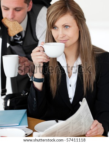 Beautiful businesswoman drinking  coffee while her husband hurry up in the morning