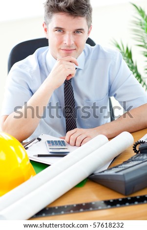 Young businessman in front of his desk in office