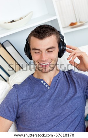 Relaxed man listening to music in living room