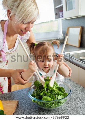 Bright mother and child cooking in the kitchen