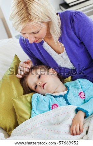 Sick cute child lying on couch in the living room
