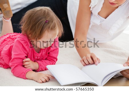 Kind mother reading a book with children on sofa