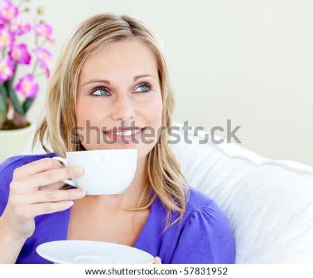 Young woman holding cup against white background