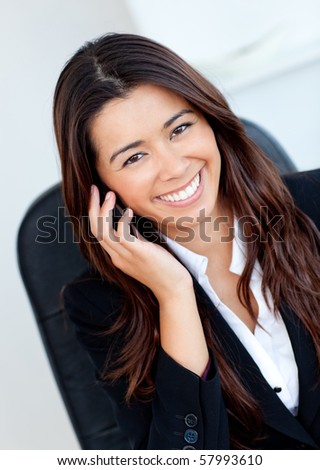 Jolly asian businesswoman talking on phone against white background