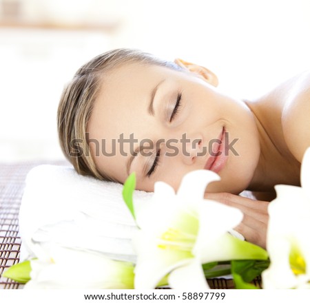 Relaxed woman lying on a massage table in a spa center