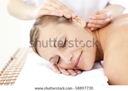 Relaxed woman receiving an acupuncture treatment in a health spa